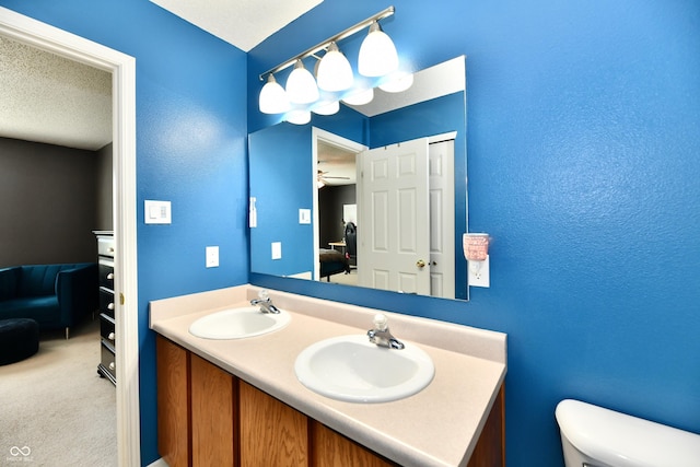 2016 Morning Light Ln, Greenwood, IN 46143 - bathroom with ensuite bathroom, double vanity, a textured ceiling, and a textured wall