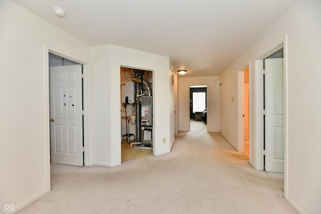 2016 Morning Light Ln, Greenwood, IN 46143 - corridor featuring light colored carpet, a textured ceiling, and water heater