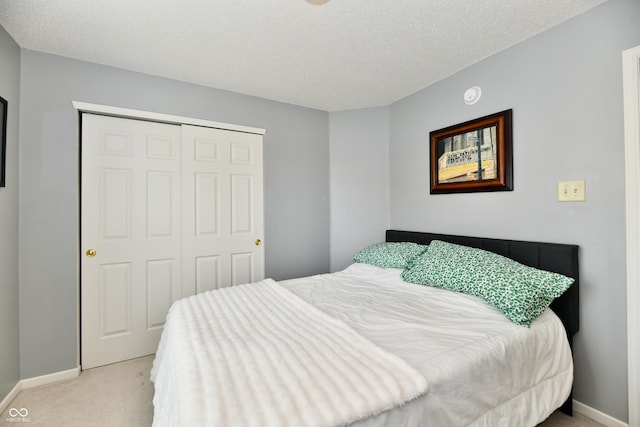 2016 Morning Light Ln, Greenwood, IN 46143 - bedroom with light colored carpet, a closet, and a textured ceiling