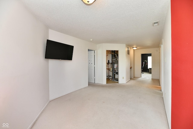 2016 Morning Light Ln, Greenwood, IN 46143 - empty room featuring light colored carpet, a textured ceiling, and gas water heater