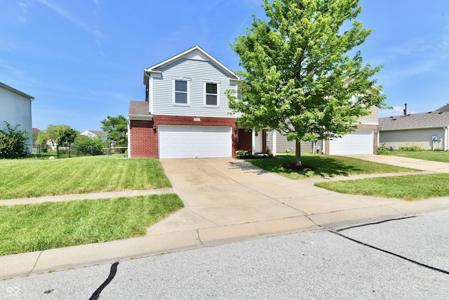 2016 Morning Light Ln, Greenwood, IN 46143 - view of front of house with brick siding, an attached garage, and concrete driveway