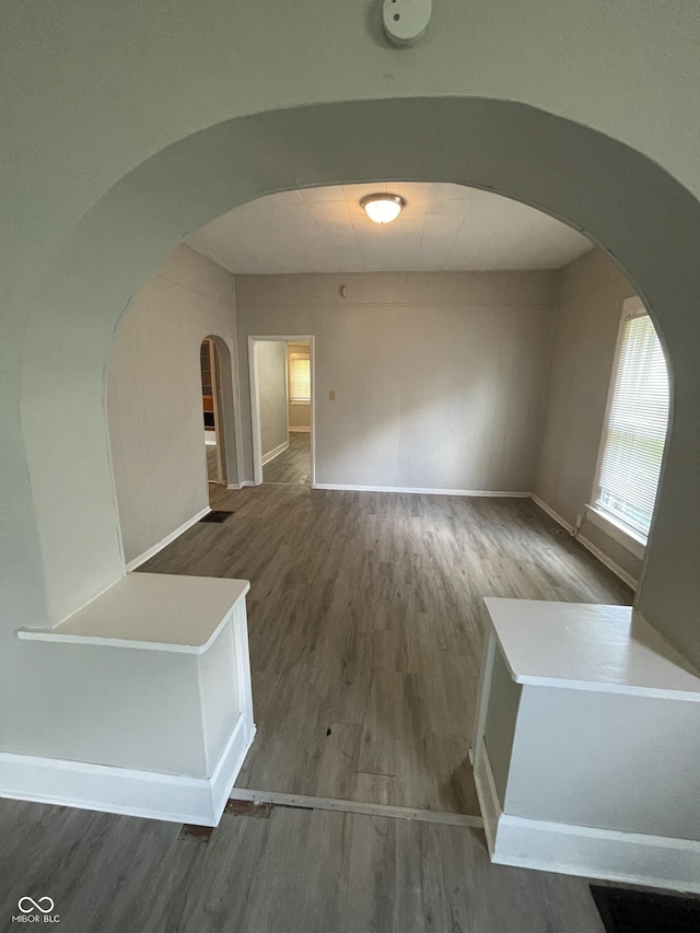 849 S Belleview Pl, Indianapolis, IN 46221 - unfurnished room featuring arched walkways and wood finished floors