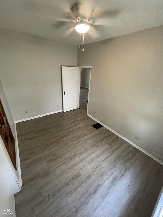 849 S Belleview Pl, Indianapolis, IN 46221 - unfurnished bedroom featuring dark wood-style floors and ceiling fan