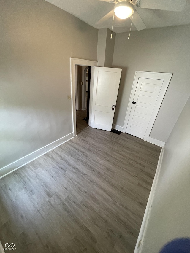 849 S Belleview Pl, Indianapolis, IN 46221 - unfurnished bedroom featuring dark wood-style flooring and a ceiling fan