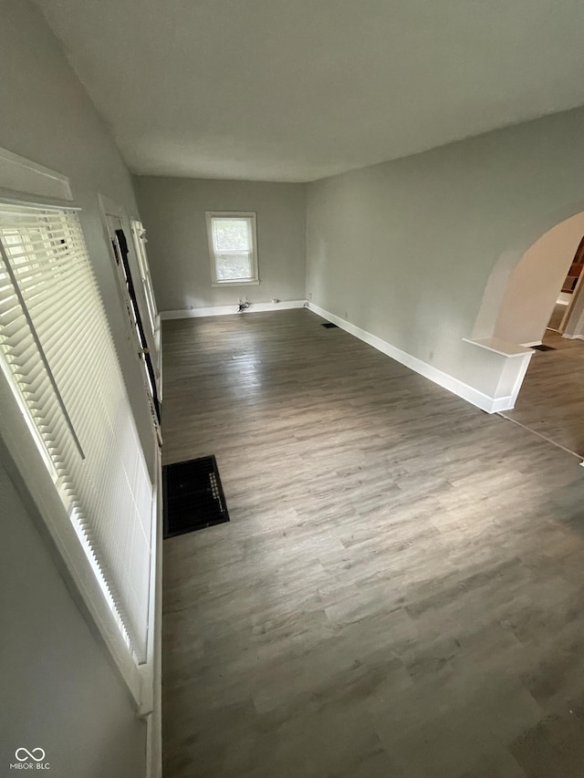 849 S Belleview Pl, Indianapolis, IN 46221 - unfurnished living room with dark wood finished floors and arched walkways