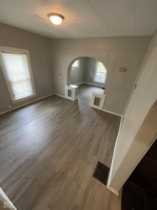 849 S Belleview Pl, Indianapolis, IN 46221 - unfurnished living room featuring arched walkways and wood finished floors