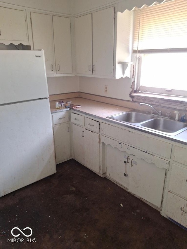 2245 Union St, Indianapolis, IN 46225 - kitchen with freestanding refrigerator, light countertops, and white cabinetry
