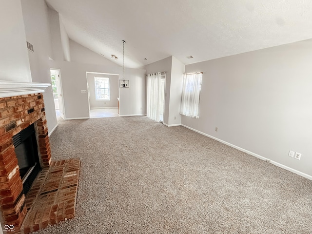 9672 River Oak Ln E, Fishers, IN 46038 - unfurnished living room with vaulted ceiling, a brick fireplace, carpet, and a textured ceiling