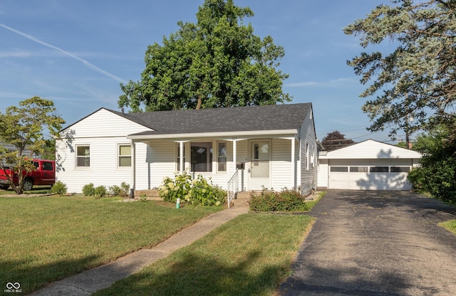 320 S Odell St, Brownsburg, IN 46112 - view of front of house with an outdoor structure, roof with shingles, a detached garage, a front yard, and covered porch