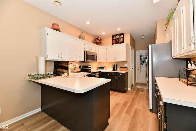 1603 Oakmere Way, Greenwood, IN 46142 - kitchen featuring a peninsula, light countertops, stainless steel appliances, white cabinets, and recessed lighting