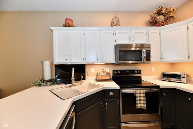 1603 Oakmere Way, Greenwood, IN 46142 - kitchen featuring appliances with stainless steel finishes, light countertops, and white cabinetry