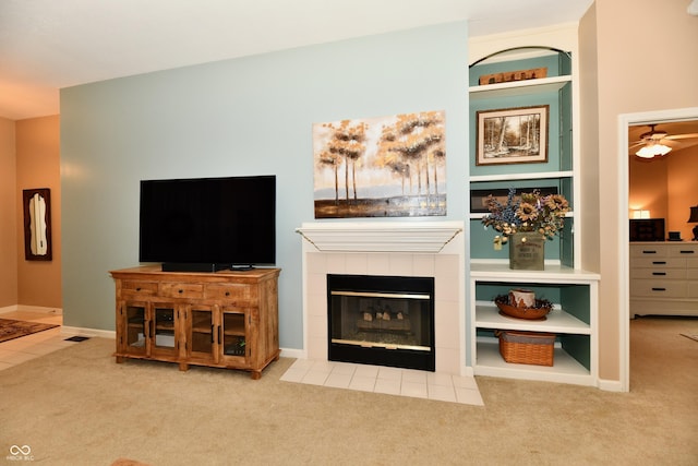 1603 Oakmere Way, Greenwood, IN 46142 - living area with carpet flooring, a tiled fireplace, built in shelves, and ceiling fan