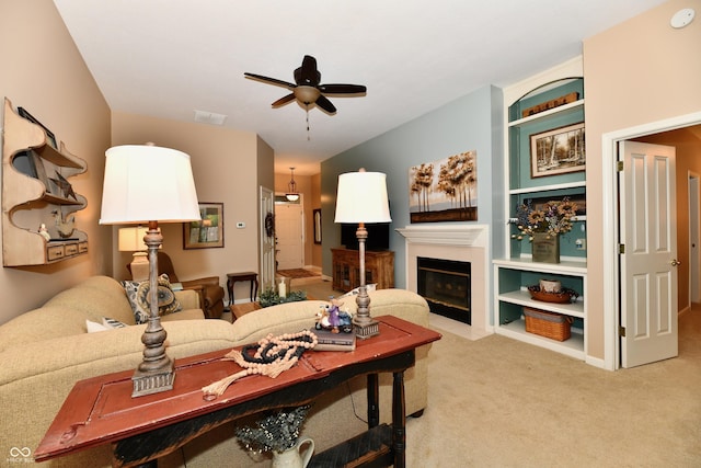 1603 Oakmere Way, Greenwood, IN 46142 - carpeted living room featuring ceiling fan, a fireplace with flush hearth, and built in shelves