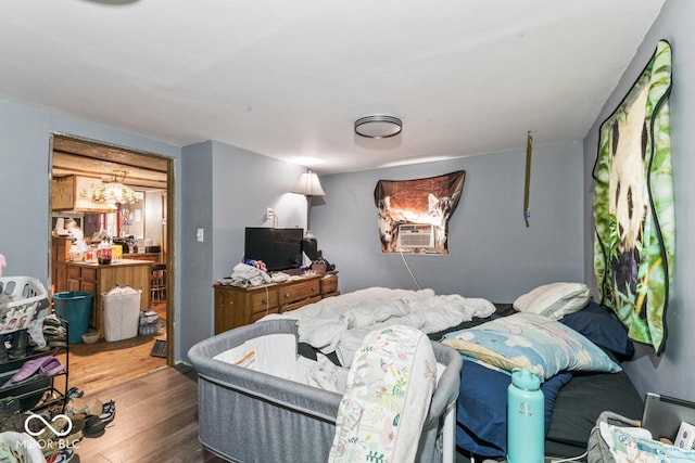 4168 Sprunica Rd, Nineveh, IN 46164 - bedroom with cooling unit, wood finished floors, and a chandelier