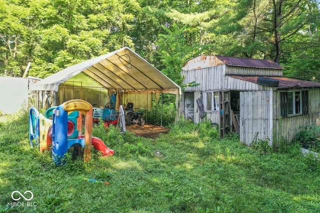 4168 Sprunica Rd, Nineveh, IN 46164 - view of jungle gym with a view of trees and an outbuilding