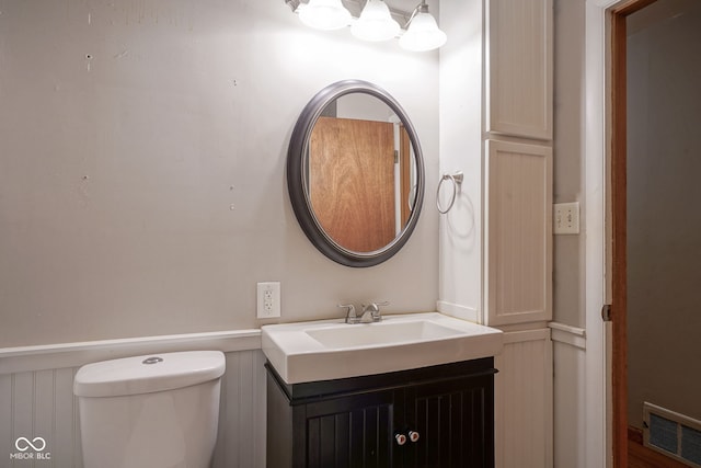 4720 Kessler View Dr, Indianapolis, IN 46220 - bathroom with vanity, a wainscoted wall, and a decorative wall
