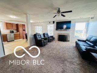 19519 Prairie Crossing Dr, Noblesville, IN 46062 - living room with a fireplace, a ceiling fan, and light carpet