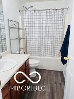 19519 Prairie Crossing Dr, Noblesville, IN 46062 - bathroom with vanity, shower / bath combo with shower curtain, and wood finished floors