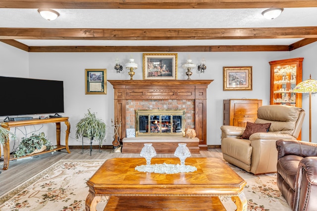 2571 Stonybrook Ln, Franklin, IN 46131 - living area featuring beamed ceiling, a fireplace, light wood-style floors, and a textured ceiling