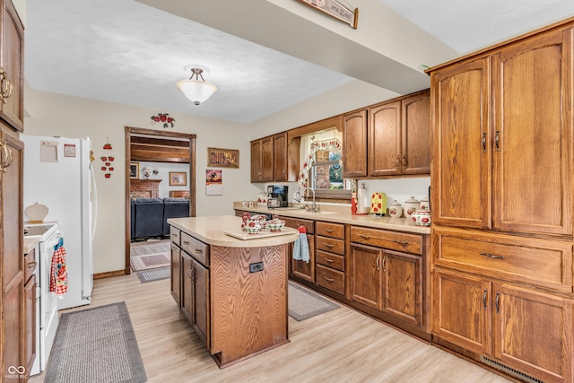 2571 Stonybrook Ln, Franklin, IN 46131 - kitchen with light countertops, light wood-style floors, a kitchen island, brown cabinetry, and a textured ceiling