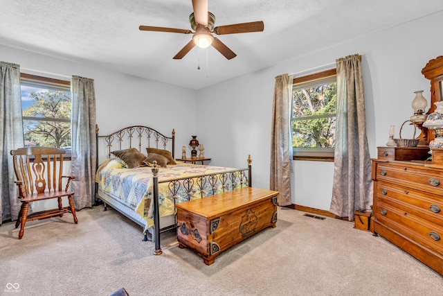 2571 Stonybrook Ln, Franklin, IN 46131 - carpeted bedroom featuring multiple windows, ceiling fan, and a textured ceiling