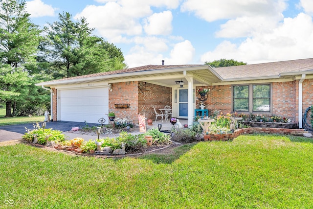2571 Stonybrook Ln, Franklin, IN 46131 - ranch-style home featuring asphalt driveway, a garage, a front lawn, and brick siding
