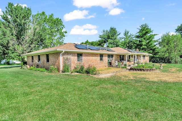 2571 Stonybrook Ln, Franklin, IN 46131 - back of property featuring solar panels, a lawn, brick siding, and a patio