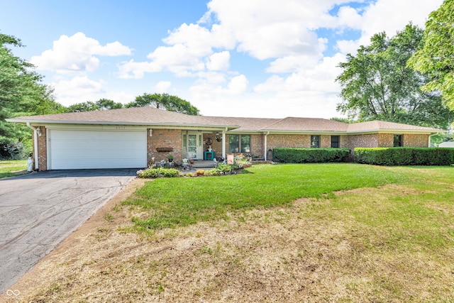 2571 Stonybrook Ln, Franklin, IN 46131 - ranch-style home featuring asphalt driveway, brick siding, a garage, a front lawn, and covered porch