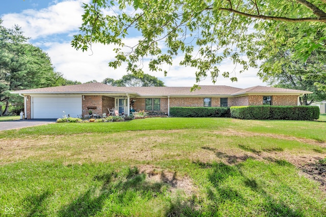 2571 Stonybrook Ln, Franklin, IN 46131 - ranch-style house with brick siding, an attached garage, asphalt driveway, and a front lawn