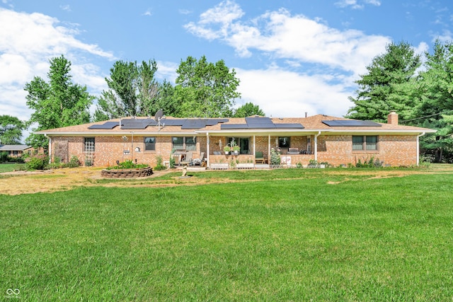 2571 Stonybrook Ln, Franklin, IN 46131 - rear view of house with a lawn, solar panels, brick siding, and a patio area