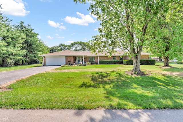 2571 Stonybrook Ln, Franklin, IN 46131 - ranch-style house with brick siding, a garage, driveway, and a front lawn