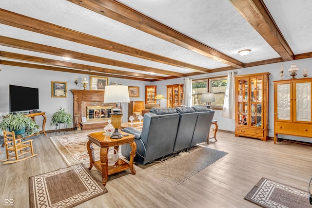 2571 Stonybrook Ln, Franklin, IN 46131 - living room with beam ceiling, wood finished floors, a textured ceiling, and a fireplace