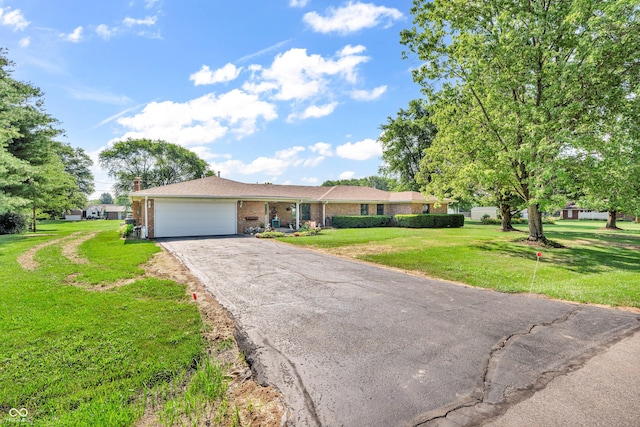 2571 Stonybrook Ln, Franklin, IN 46131 - ranch-style home with an attached garage, brick siding, asphalt driveway, and a front yard
