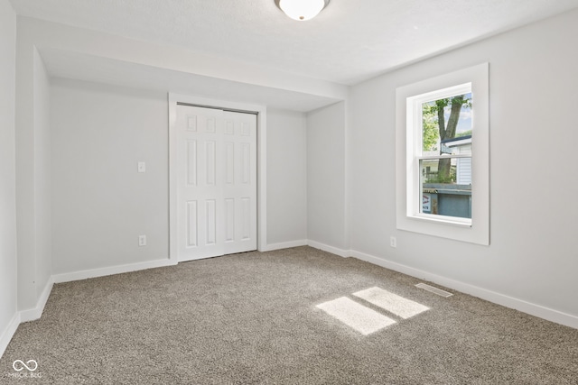 135 S Dr, Anderson, IN 46013 - unfurnished bedroom featuring carpet and a closet