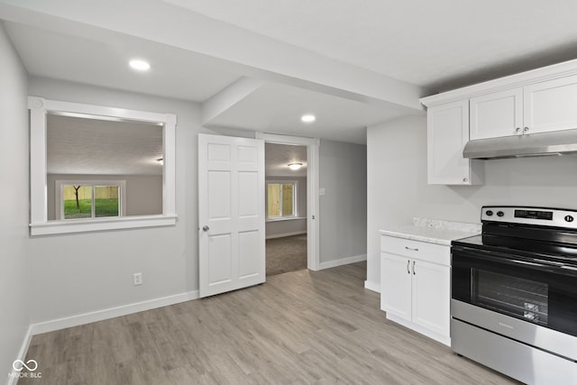 135 S Dr, Anderson, IN 46013 - kitchen with electric stove, under cabinet range hood, light countertops, white cabinetry, and recessed lighting