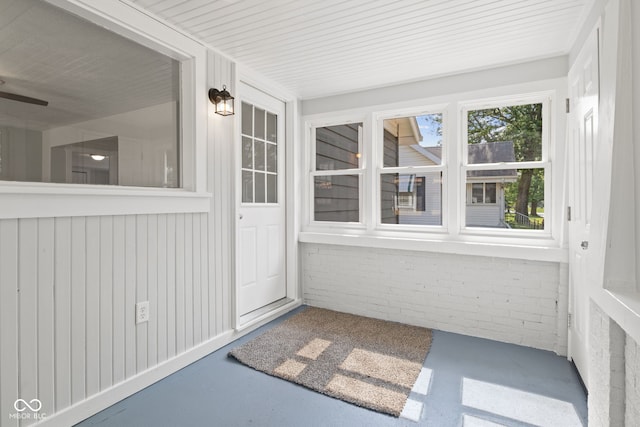 135 S Dr, Anderson, IN 46013 - unfurnished sunroom with brick wall and concrete flooring