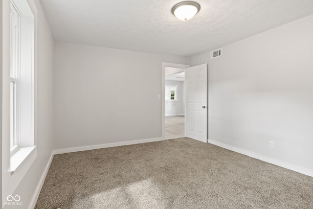 135 S Dr, Anderson, IN 46013 - empty room featuring carpet and a textured ceiling