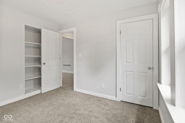 135 S Dr, Anderson, IN 46013 - unfurnished bedroom featuring carpet and baseboards