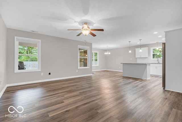 354 Mill Spgs, Fillmore, IN 46128 - unfurnished living room featuring plenty of natural light, a ceiling fan, and a chandelier