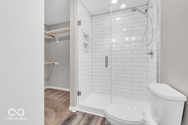 354 Mill Spgs, Fillmore, IN 46128 - bathroom with a walk in closet, a stall shower, and wood finished floors