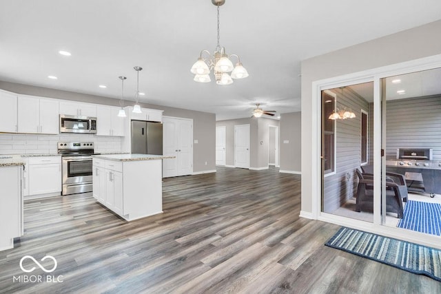 354 Mill Spgs, Fillmore, IN 46128 - kitchen with stainless steel appliances, a chandelier, wood finished floors, white cabinets, and a center island