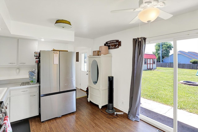 2630 Flintwood Dr, Columbus, IN 47203 - kitchen featuring stainless steel appliances, separate washer and dryer, light countertops, wood finished floors, and white cabinetry