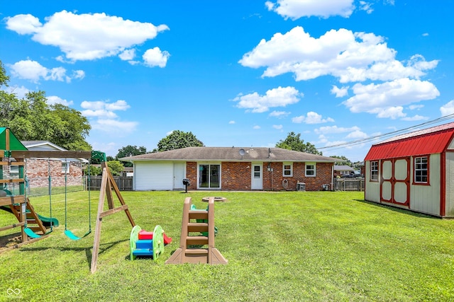 2630 Flintwood Dr, Columbus, IN 47203 - back of house featuring a playground, brick siding, a storage unit, and a fenced backyard