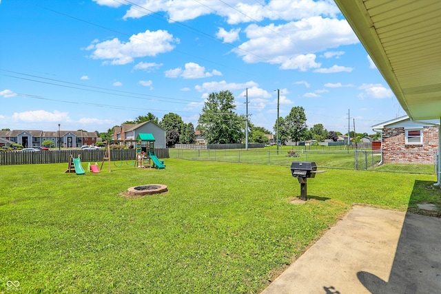 2630 Flintwood Dr, Columbus, IN 47203 - fenced backyard with a playground and a fire pit