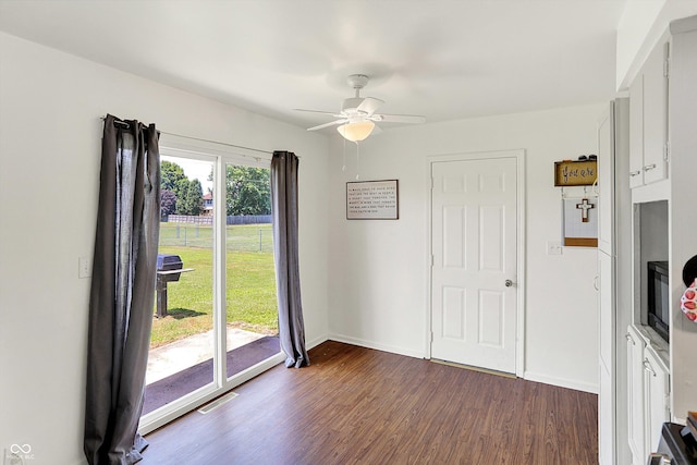 2630 Flintwood Dr, Columbus, IN 47203 - unfurnished dining area featuring dark wood finished floors and a ceiling fan
