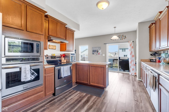 1397 Greenbriar Way, Franklin, IN 46131 - kitchen with appliances with stainless steel finishes, under cabinet range hood, a peninsula, light countertops, and dark wood-type flooring
