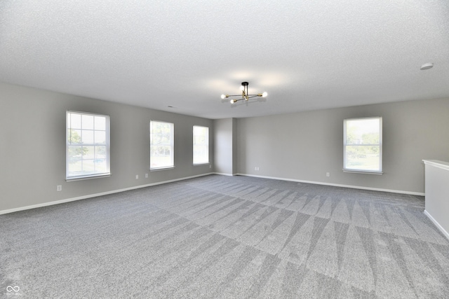 12622 White Rabbit Dr, Indianapolis, IN 46235 - unfurnished room featuring a chandelier, a textured ceiling, and carpet floors
