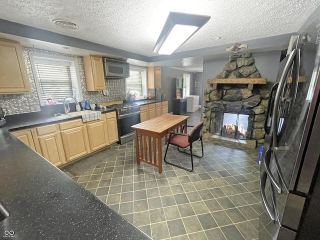 1446 W State Highway 46, Spencer, IN 47460 - kitchen with appliances with stainless steel finishes, a textured ceiling, light brown cabinetry, dark tile patterned flooring, and dark countertops