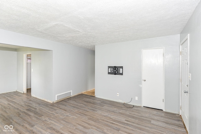 4218 N Irvington Ave, Indianapolis, IN 46226 - spare room with wood finished floors and a textured ceiling