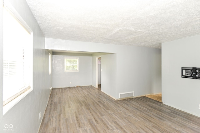 4218 N Irvington Ave, Indianapolis, IN 46226 - empty room featuring wood finished floors and a textured ceiling